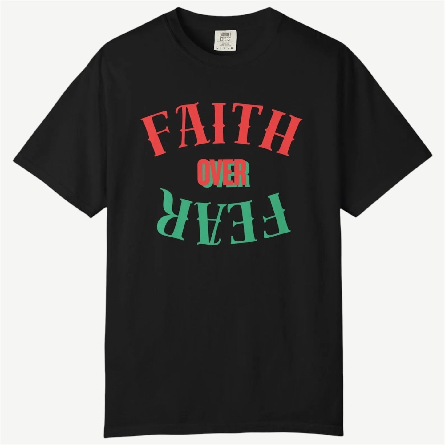 A black short-sleeve crewneck t-shirt featuring a graphic text design on the front that reads 'FAITH OVER FEAR' in red and green stylized lettering, displayed against a light gray background.