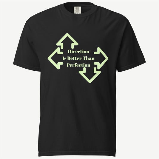 A black short-sleeve crewneck t-shirt with a light green graphic on the chest. The graphic features four arrows pointing outwards, surrounding the text 'Direction Is Better Than Perfection' in a light green serif font.