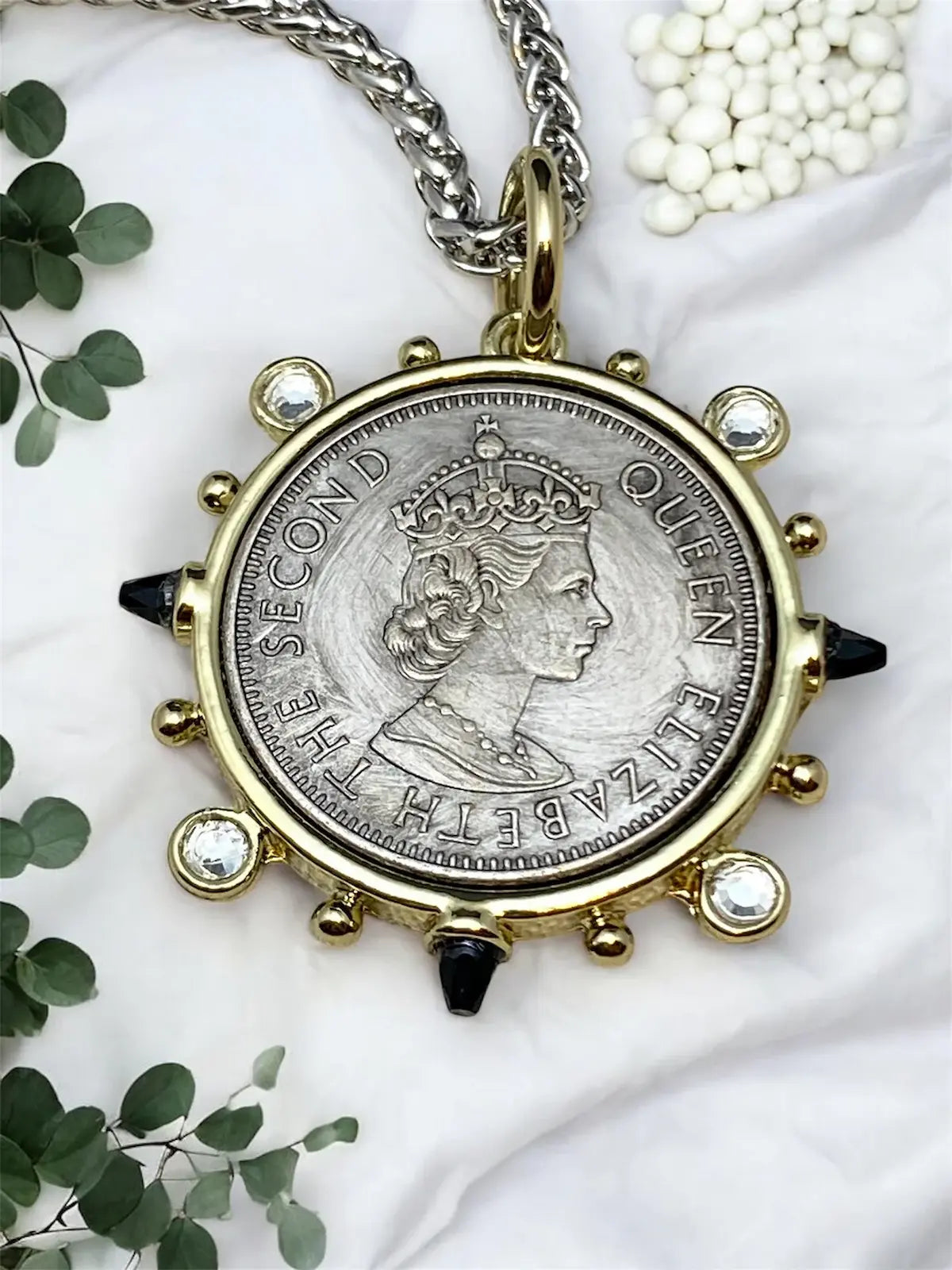Necklace with a coin pendant featuring Queen Elizabeth II.